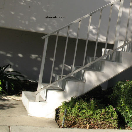 concrete stairway with metal handrail safety problems