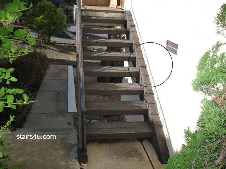 wood stairs against stucco exterior wall can create gaps for water damage