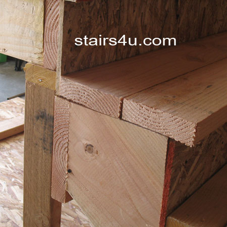 side view of 2x6 wood stair treads on stringer