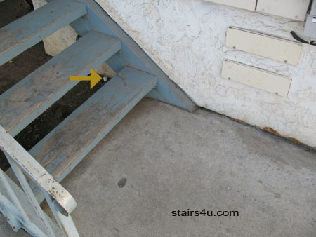 covered sprinkler pipe under damaged wood stairway